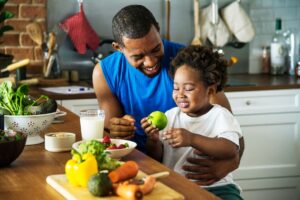 Dad and daughter cooking in kitchen